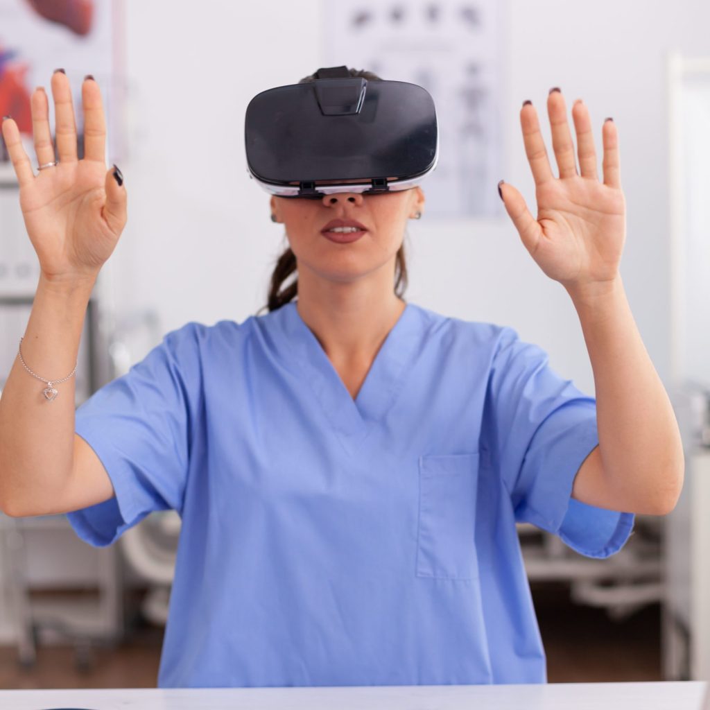 Female health worker wearing virtual reality goggles.