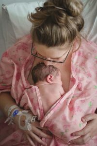 Image of female holding infant with skin to skin contact