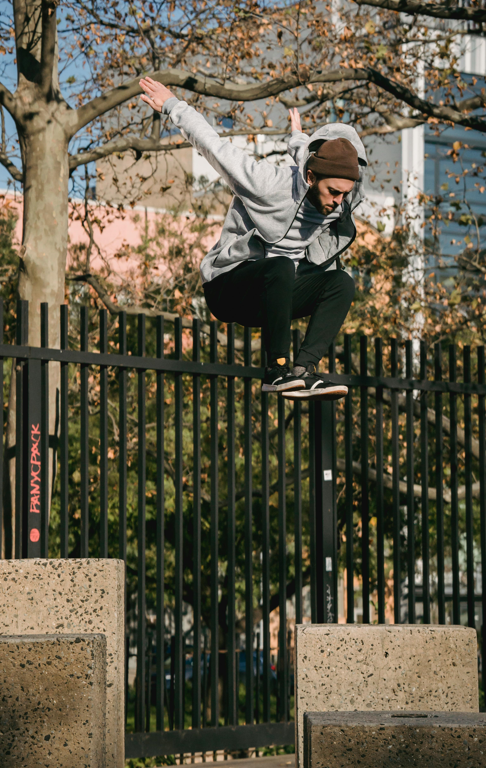 Young man jumping a fence