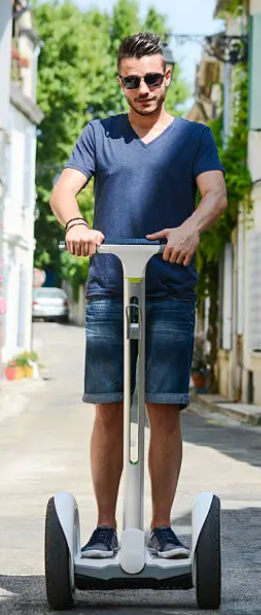 A white guy in sunglasses riding a segway