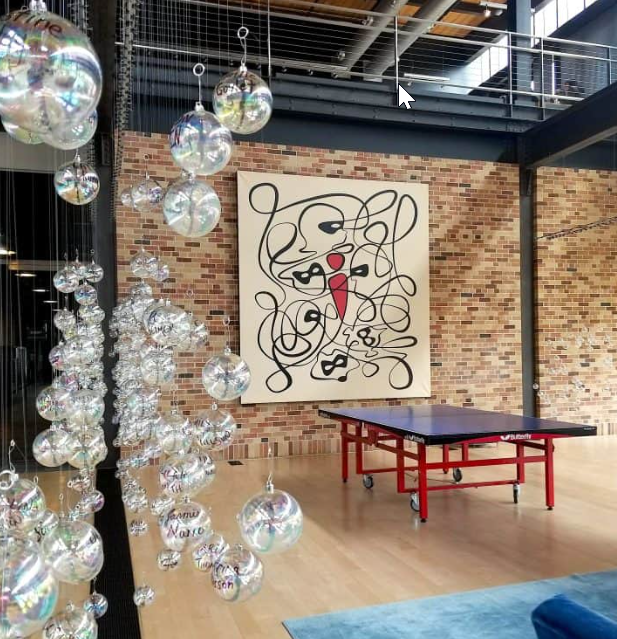 Another appealing interior of Pixar featuring art and a ping pong table