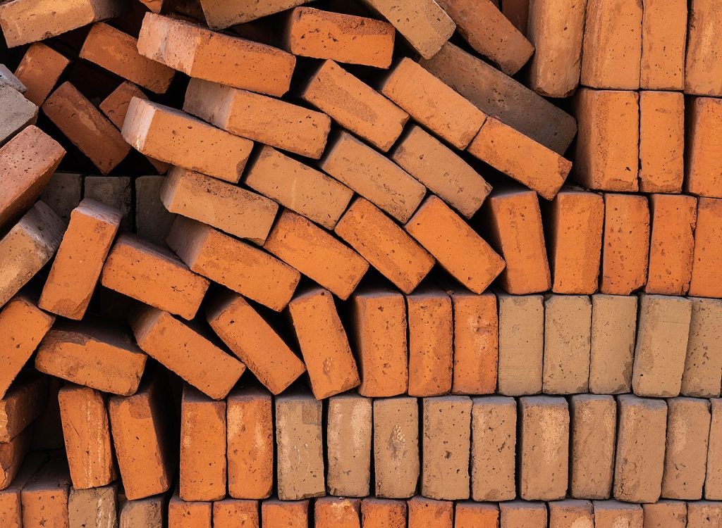 Image depicts a partially collapsed stack of bricks.