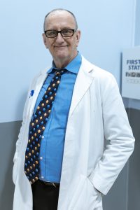 A smiling general practitioner looking directly at the camera