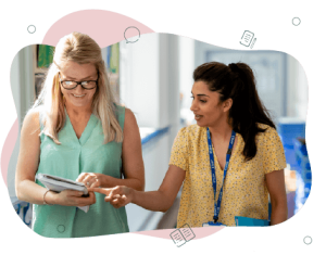 Two teacher walking down a hallway discussing their observations