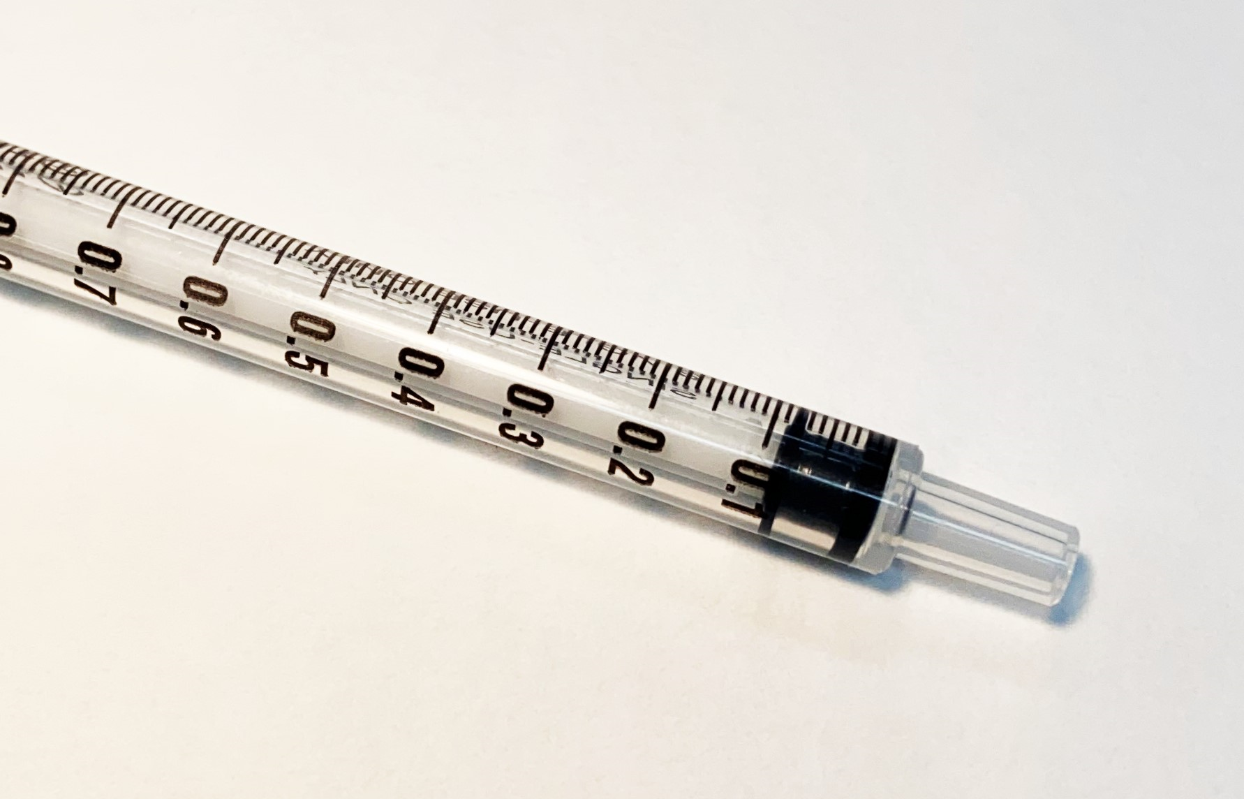 A 1 ml Luer lock style syringe with 0.1 ml major increments each subdivided into 0.01 ml gradations.
