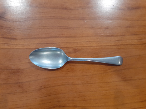 Top down view of a metal spoon.