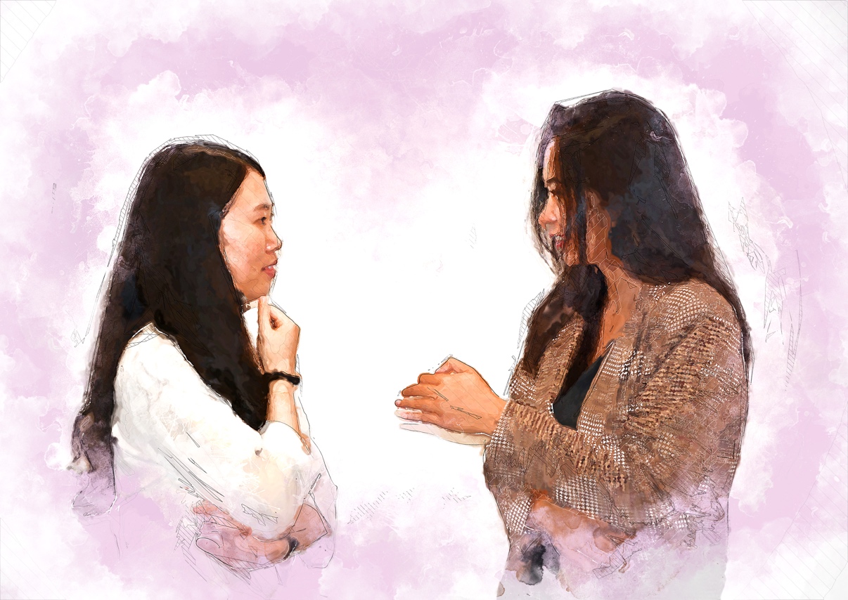 Charlotte and Yuwen stand facing each other, deep in conversation.