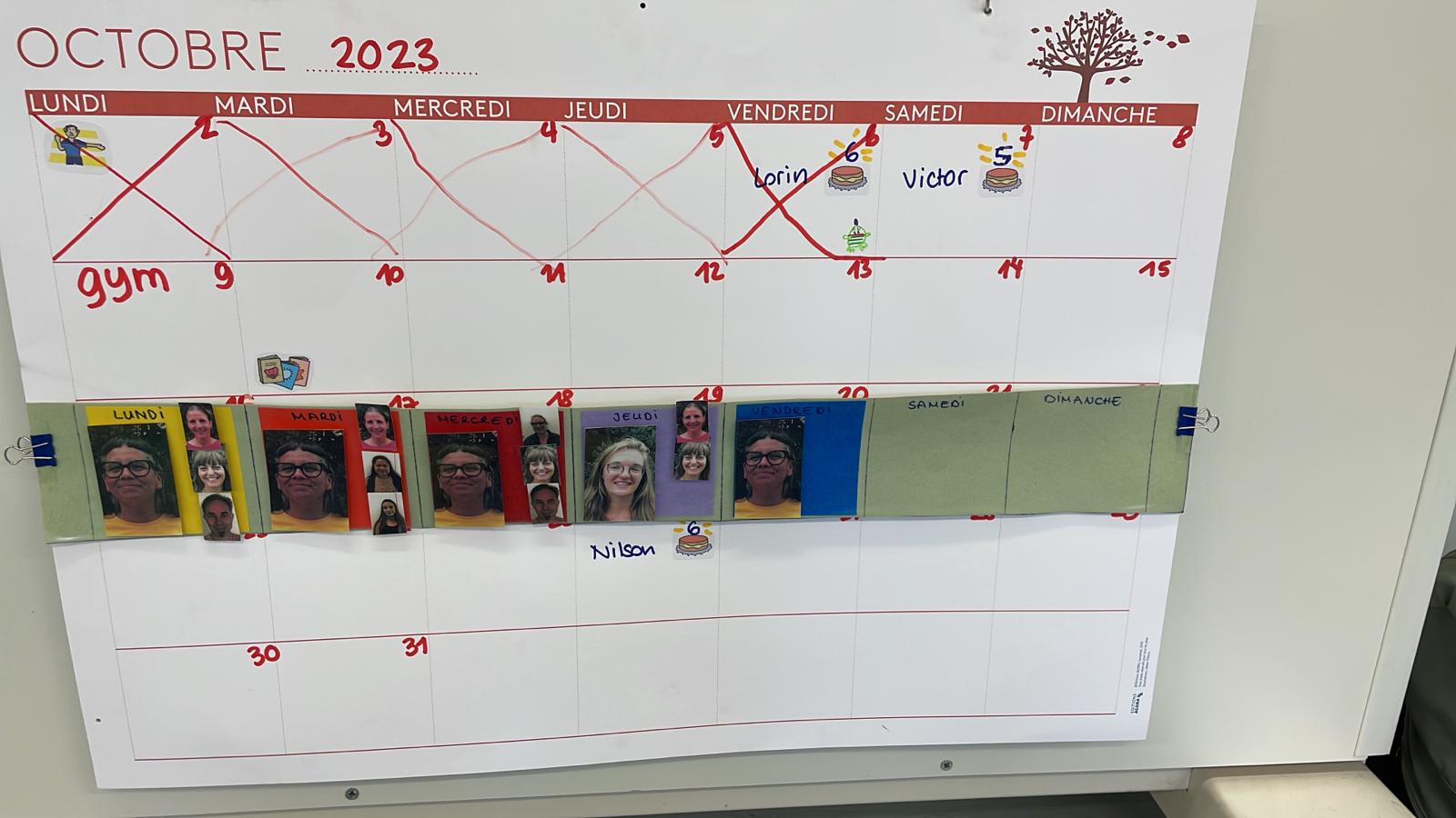 top image is hanging cloth calendar banner with moveable velcro labels to indicate day, month and year. bottom image is paper wall calendar showing the month of October with some dates crossed out and phots of staff members as labels