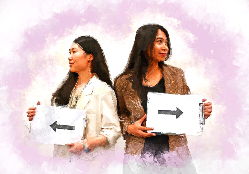 Charlotte and Yuwen stand facing away from each other, each holding a piece of paper with an arrow on it.